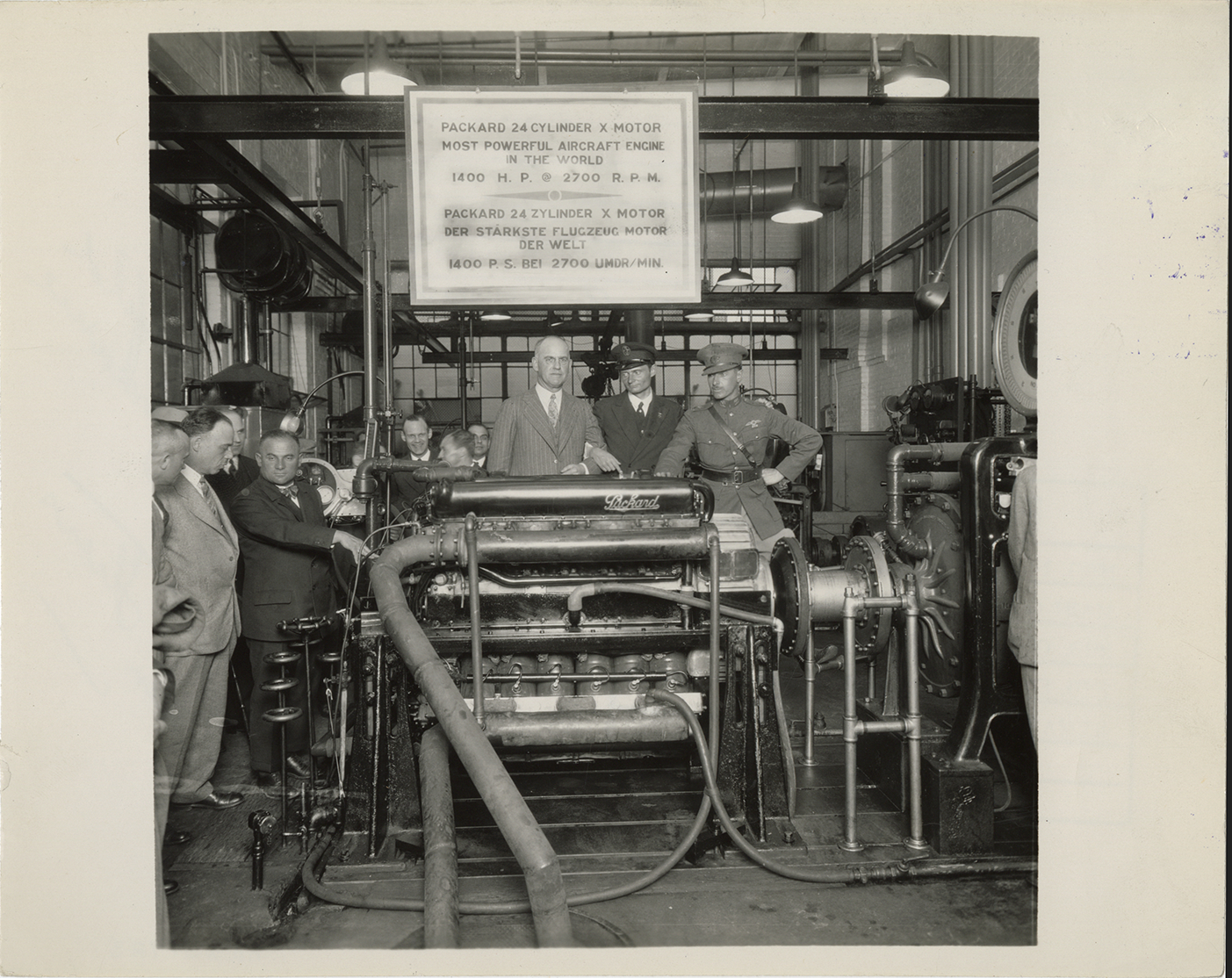 Alvan Macauley posing with Packard 24 cylinder X aircraft motor