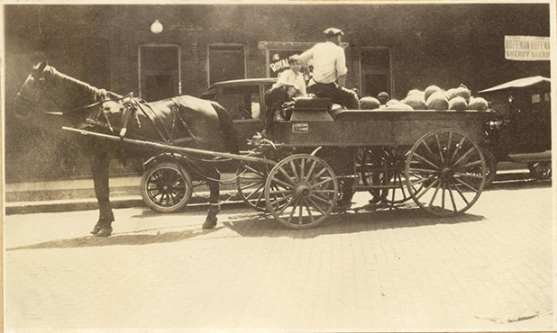 Men peddling watermelons
