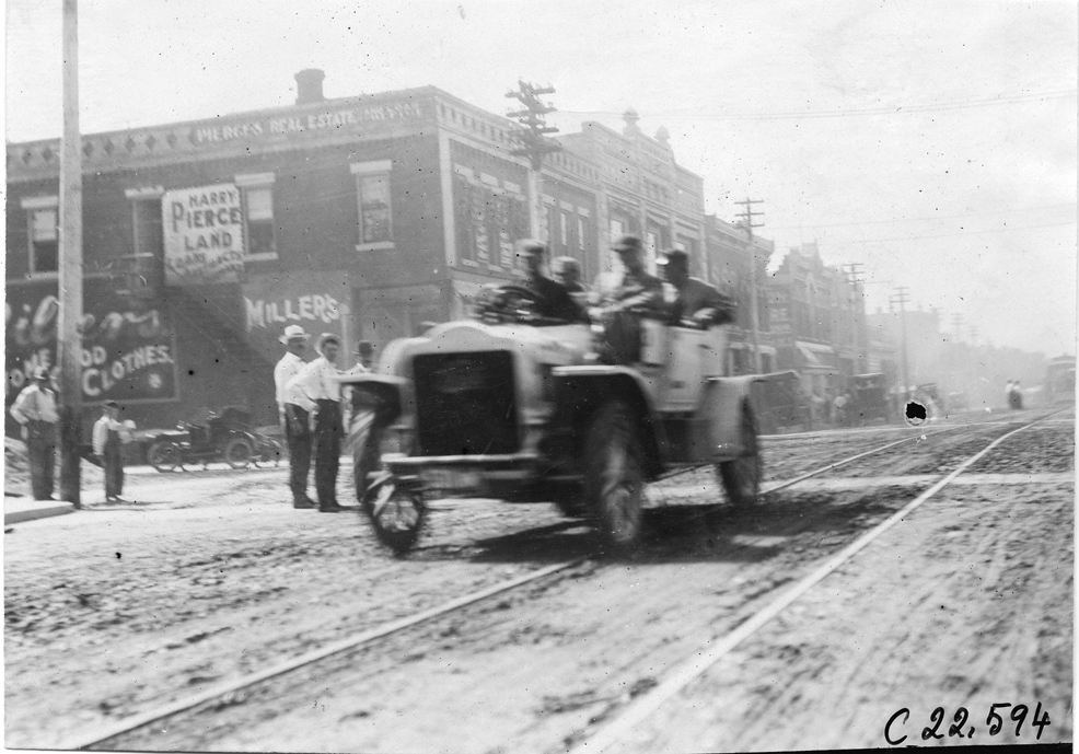 Searles in White Steamer car on city street in Junction City, Kansas, at 1909 Glidden Tour DPL