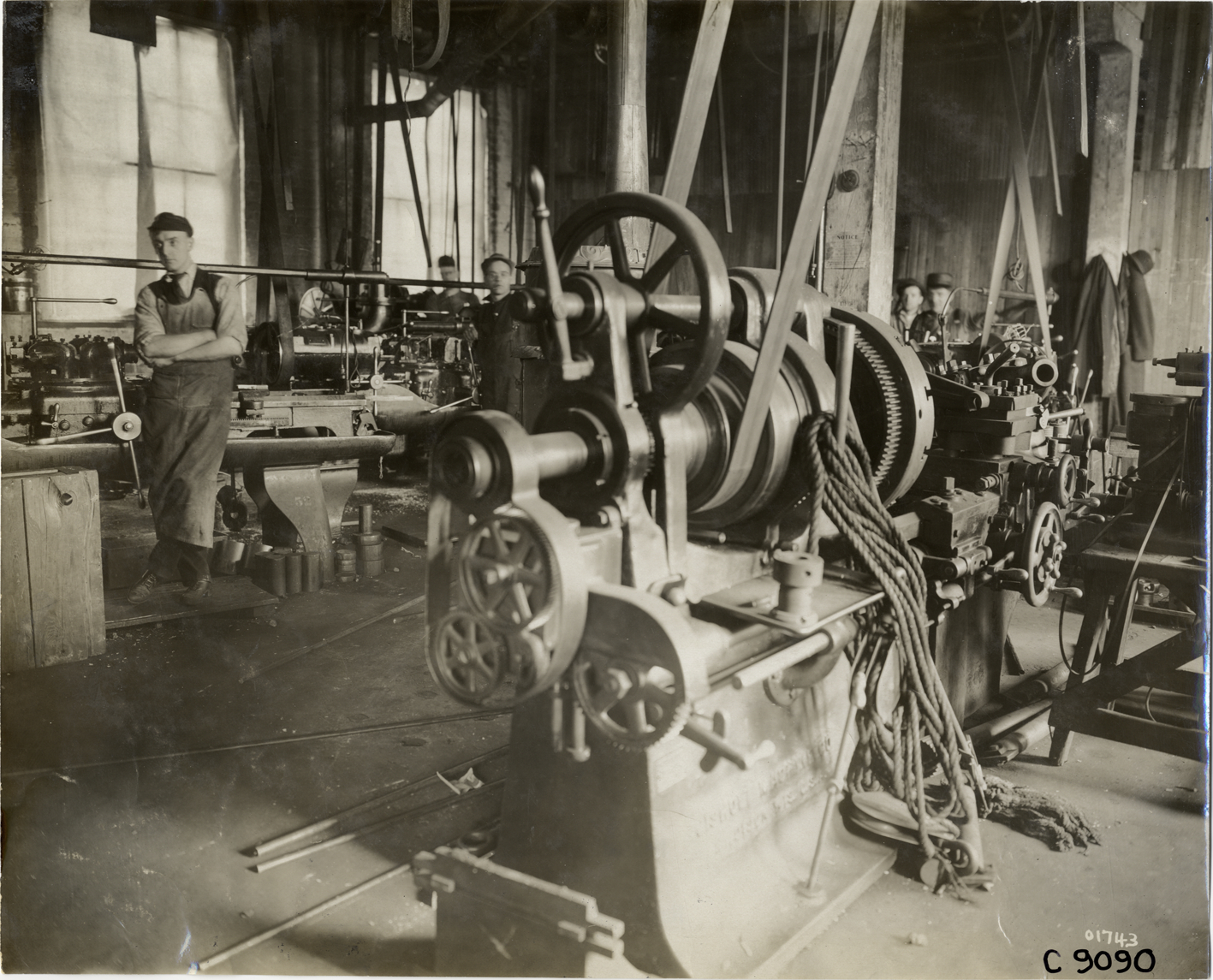 Workers with machinery in Auto Parts Manufacturing Company factory