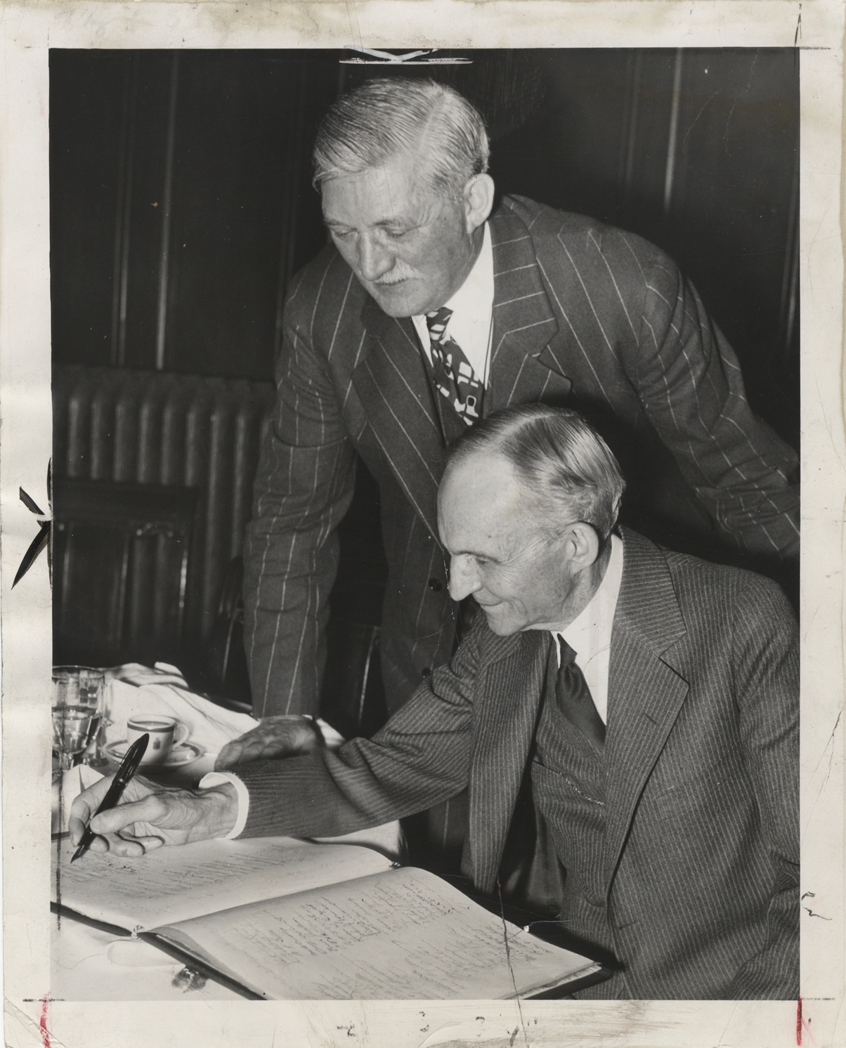 Henry Ford signing memory book for William S. Knudsen DPL DAMS