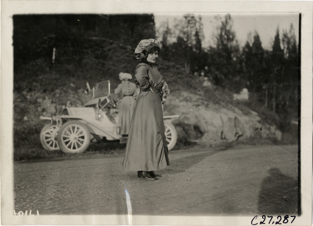 Blanche Stuart Scott standing in road, 1910 New York to San Francisco